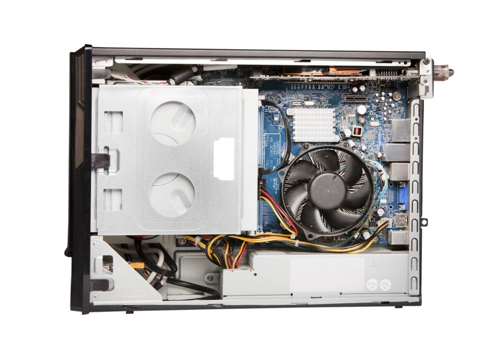 An old gaming PC with one face opened, showing processor, motherboar and fan. Concept image for costs of gaming PC parts