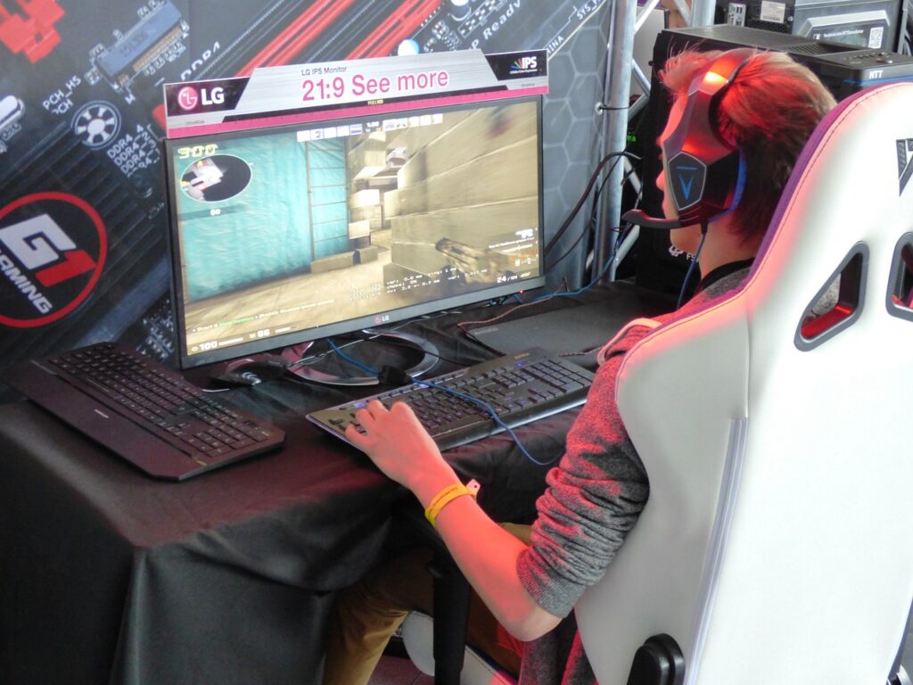 A man playing on a gaming monitor. Concept image for using a 165 Hz screen for gaming.