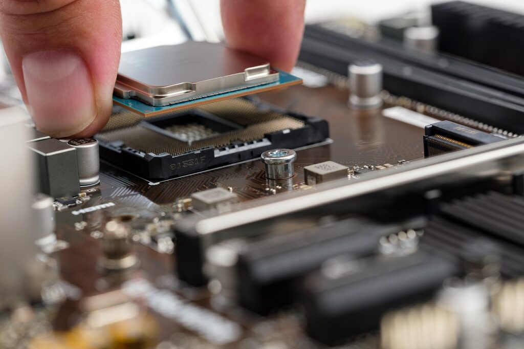 A man inserting a CPU inside a motherboard. Concept image for how CPU GHz matters in gaming.