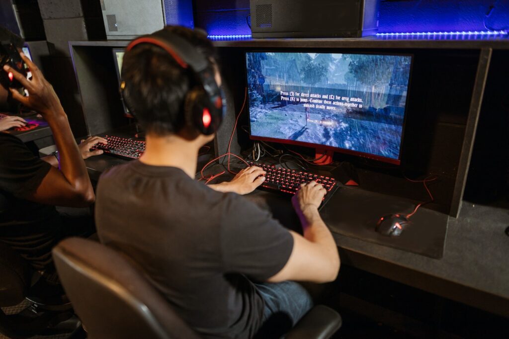 A man using a curved gaming monitor and playing a game on it. Concept image for using a gaming monitor as a regular monitor.