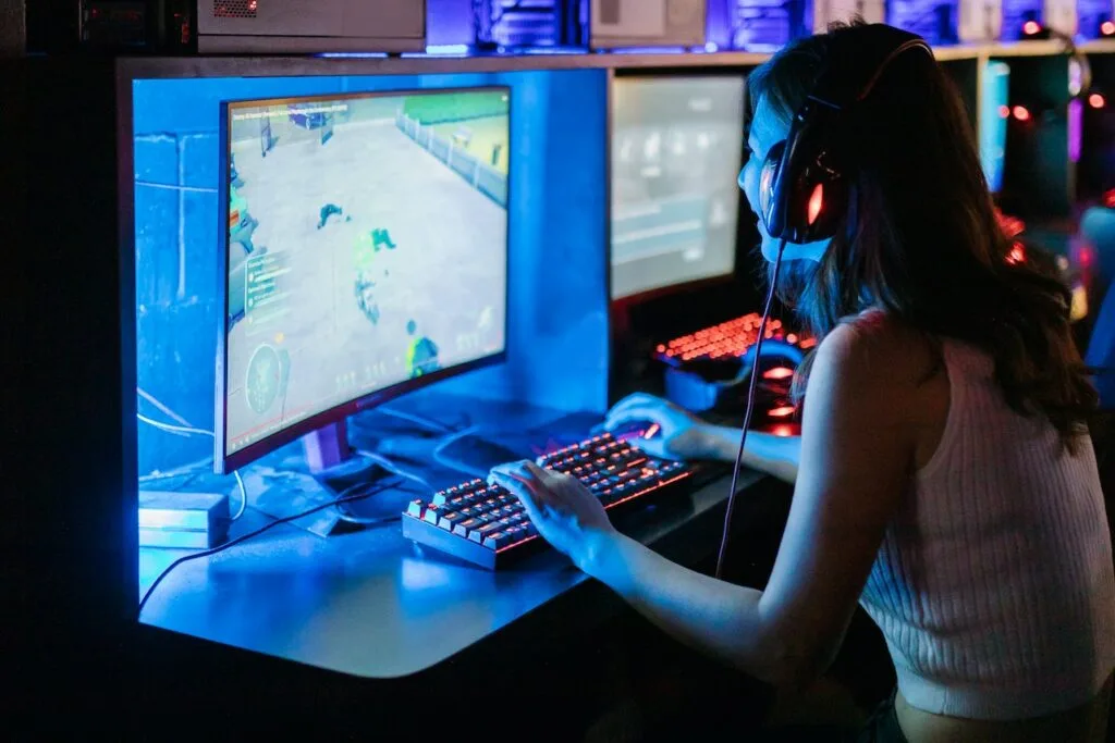 A girl watching at a gaming monitor while gaming... Concept image for 300 nits brightness for a gaming PC.