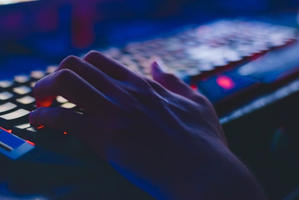 A man placing hand over WASD of a gaming mechanical keyboard. Concept image of positioning of hands over a keyboard.