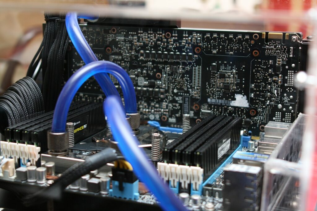 Two blue pipes connected to the CPU of a water-cooled PC. Concept image for showing alternatives to PC fans.