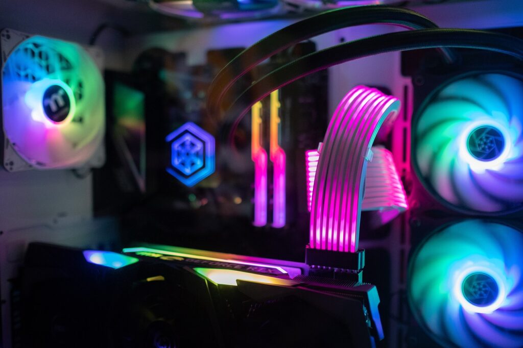 An RGB computer's picture showing its internal part where fans are visibly showing different colors. Concept image of electricity and power consumption of a gaming PC.