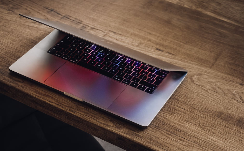 A Razer laptop placed on a wooden table.