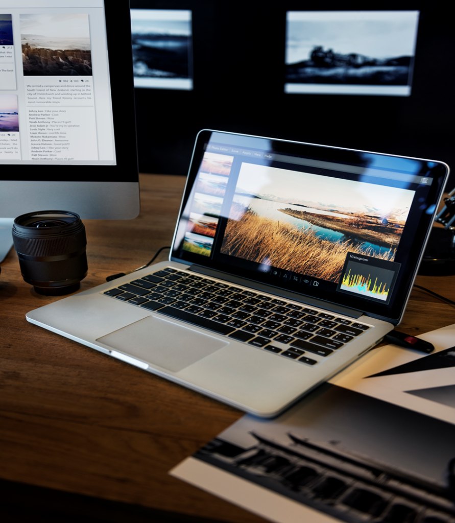 A laptop placed on a table along with some files.