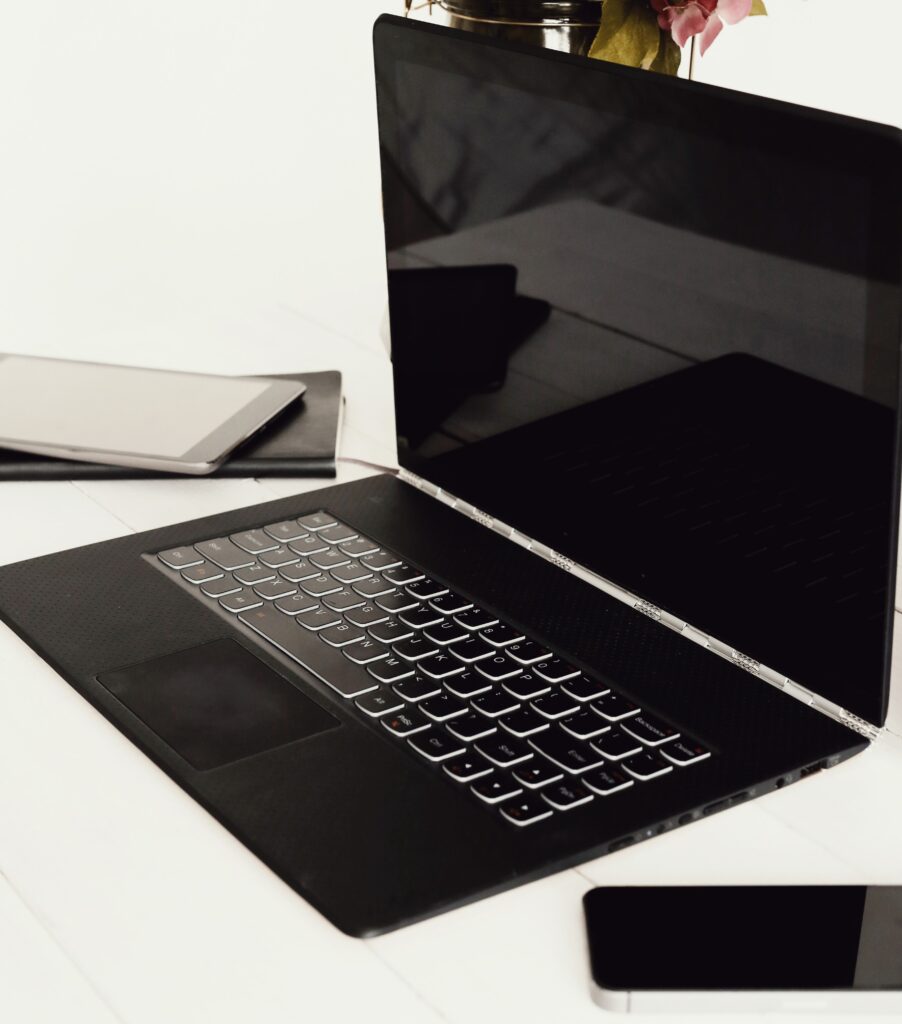 A gaming laptop placed on a white table.