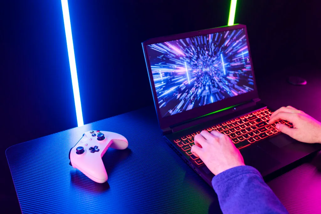 A gamer playing on a gaming laptop
