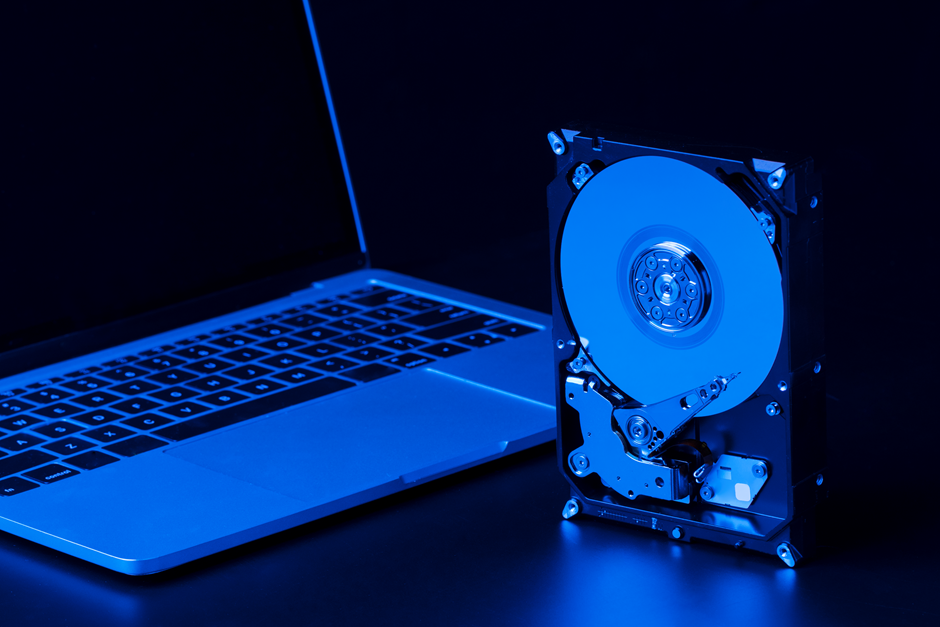 A Gigabyte gaming laptop placed on a table with a CD rom.